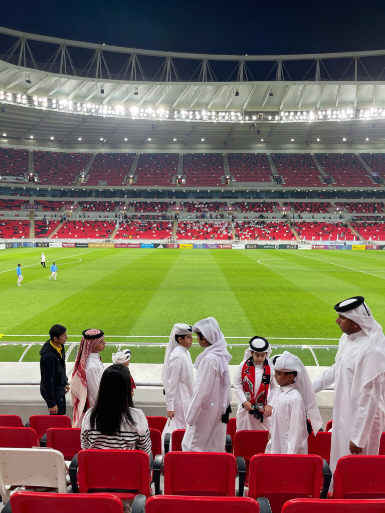 Children and parents preparing to watch a soccer match in a stadium