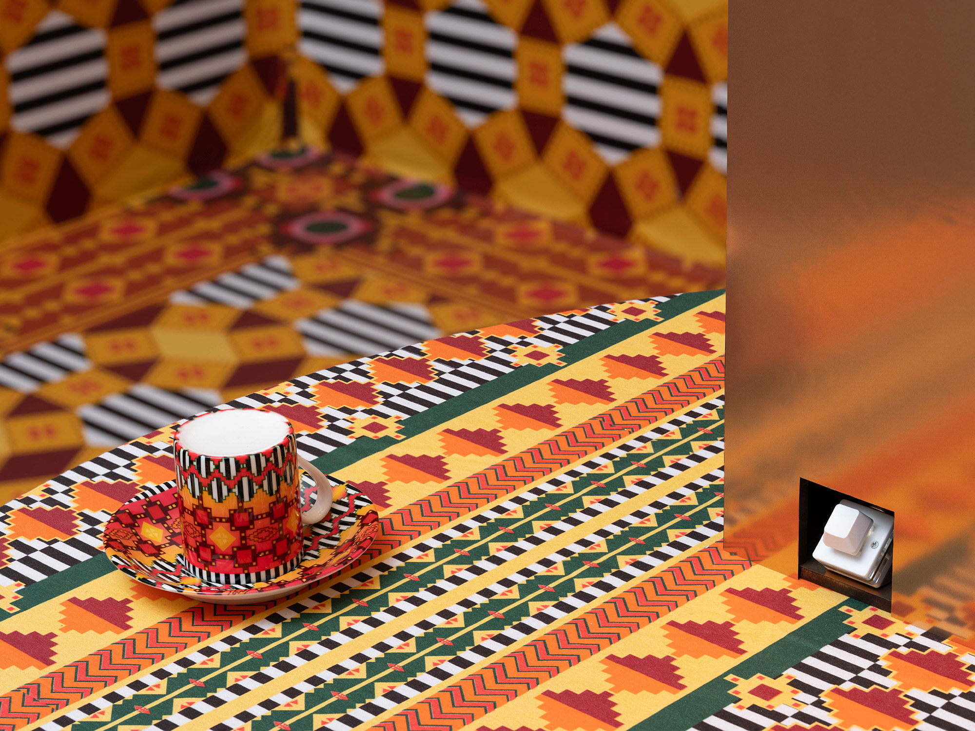 Small cup of coffee in a brightly colored and patterned setting