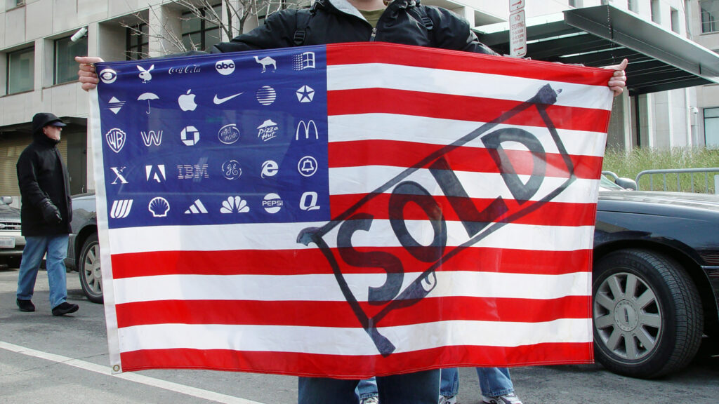 American flag with corporate logos for stars, and a large "SOLD" drawing across the stripes