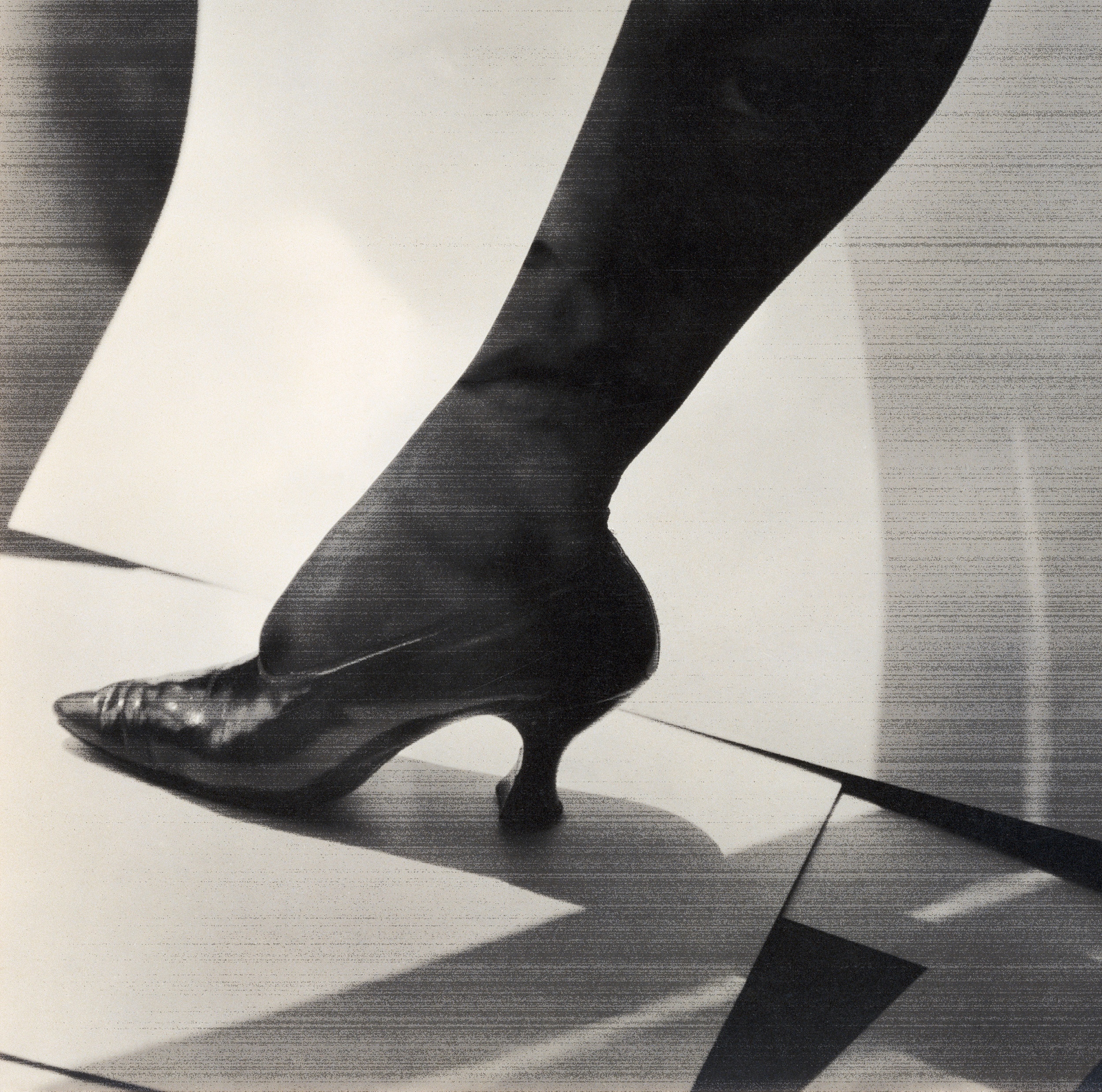 a leg in stockings and high heels, in black and white