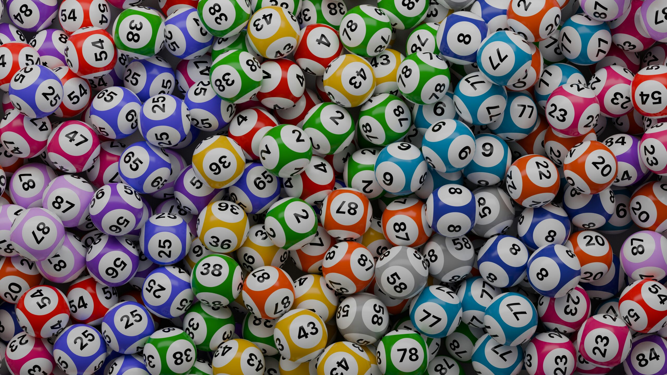 A dense pile of colorful, glossy bingo balls featuring various printed numbers.