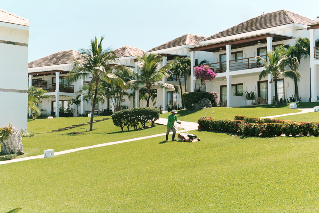 man mowing hotel lawn