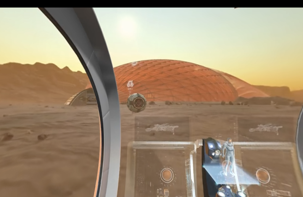 video still looking through a windshield toward a dome construction in the desert