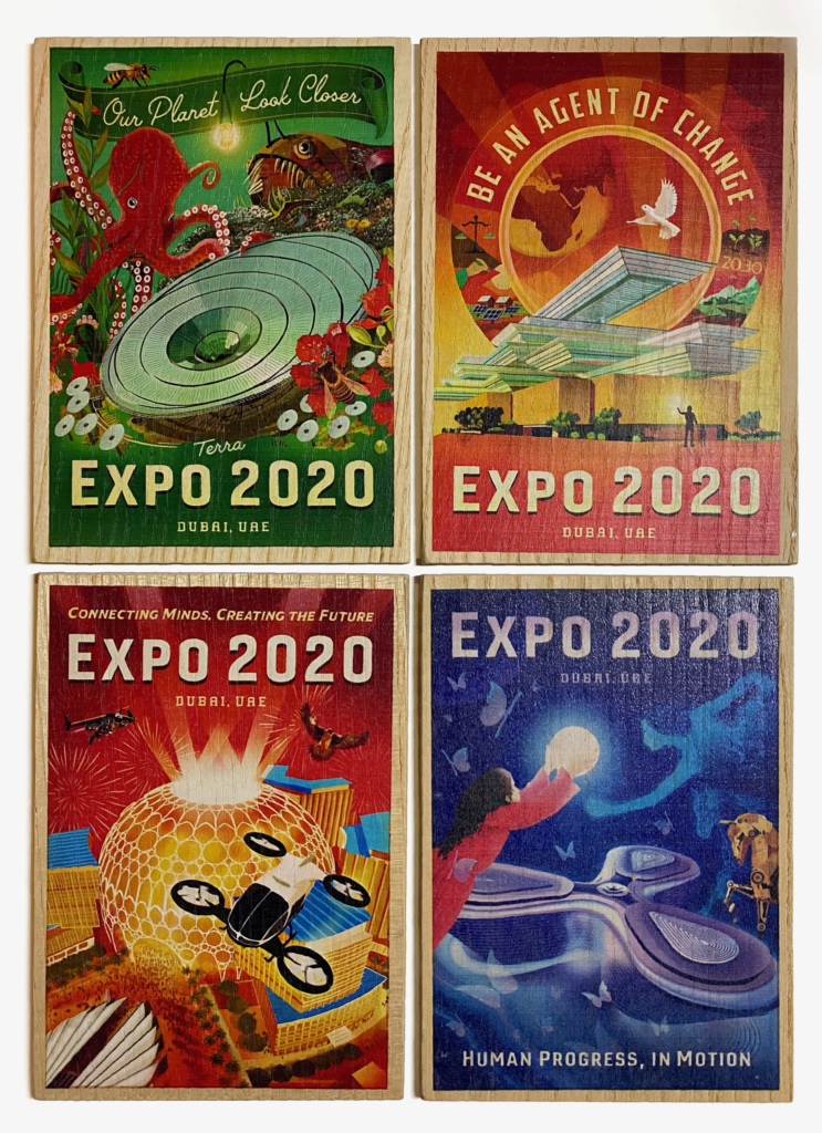 an array of four brightly colored plaques depicting futuristic scenes