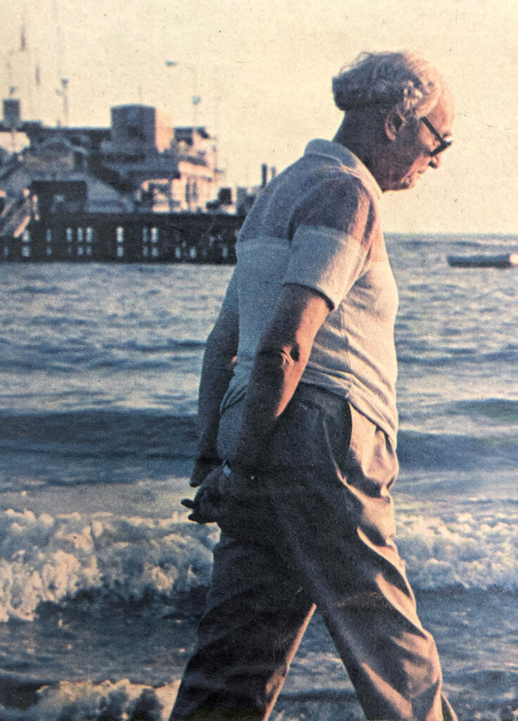 Arvid Pardo, older man with gray hair and hands clasped behind his back walking on a beach