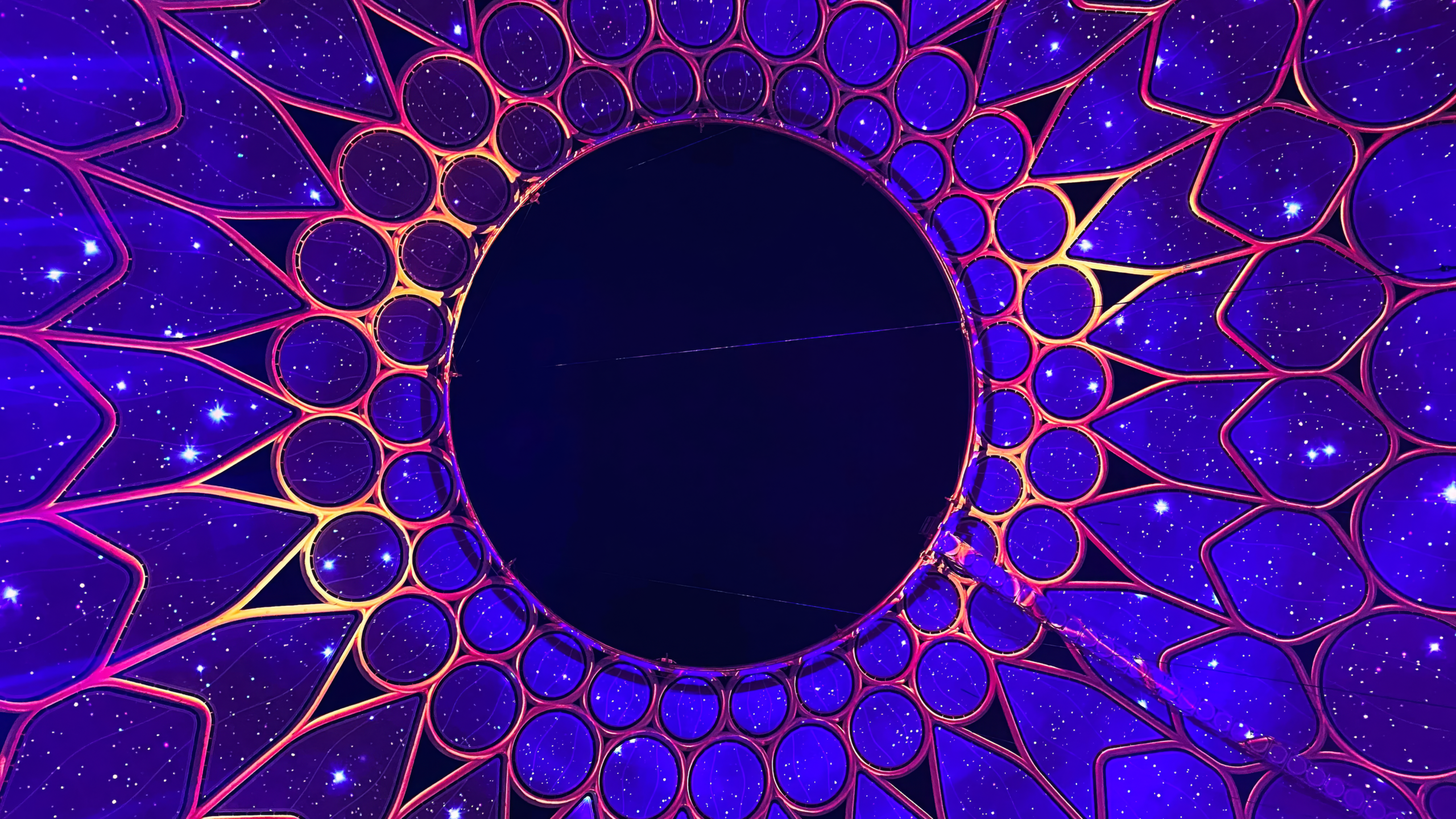 Geometric design with center at middle and purple and red screen radiating out from center